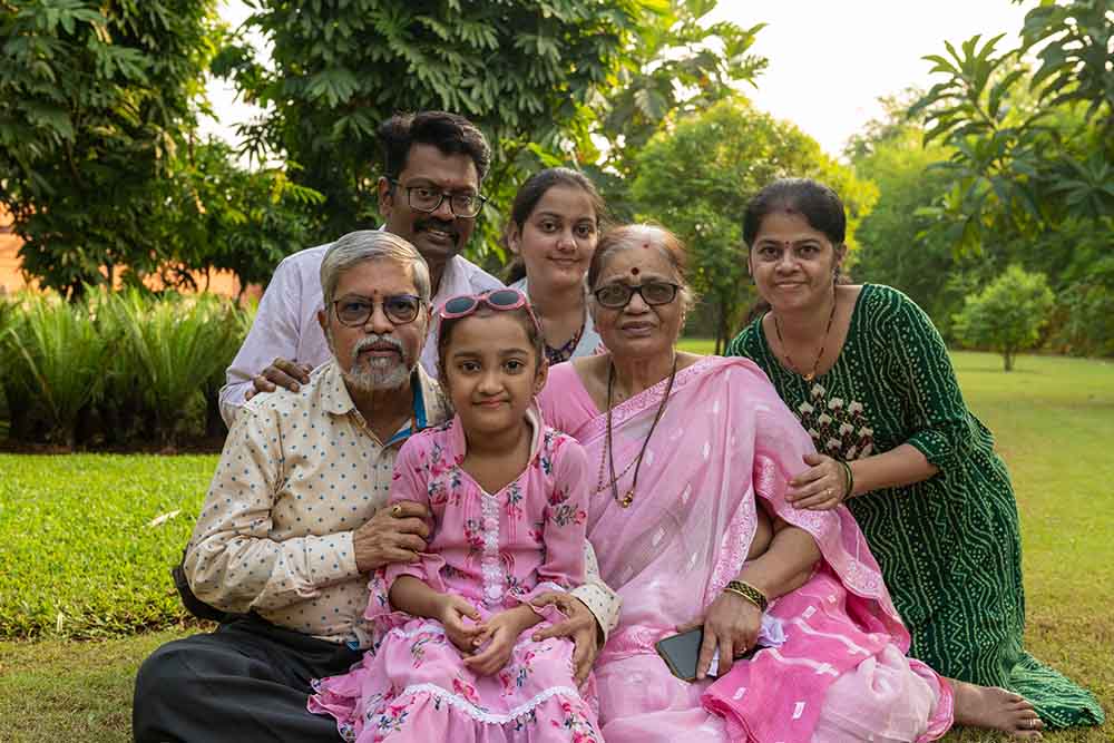 Durva smiles and poses with her grandparents, her parents, and her older sister, Anvisha
