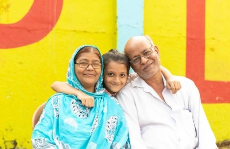 Smile Train patient Humera smiling with her mother and father after cleft surgery